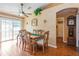 Dining room with wood table and chairs adjacent to living area and backyard access at 1395 Deland Ave, Orange City, FL 32763