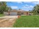 Inviting single-story home with a well-manicured lawn and a spacious driveway at 1395 Deland Ave, Orange City, FL 32763