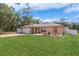 Well-maintained home with a verdant lawn and beautiful landscaping at 1395 Deland Ave, Orange City, FL 32763