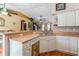 Open-concept kitchen with white cabinets, stainless sink and an eat-in counter at 1395 Deland Ave, Orange City, FL 32763