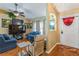 Comfortable living room featuring a large TV, plush seating, and ample natural light at 1395 Deland Ave, Orange City, FL 32763