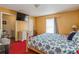 Spacious main bedroom featuring a TV, ample lighting, and ensuite bathroom access at 1395 Deland Ave, Orange City, FL 32763