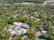 Birds-eye view of community featuring pools, shuffleboard courts, and lush surrounding greenery at 149 E Plantation Blvd, Lake Mary, FL 32746