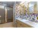 Bathroom featuring a double sink vanity, floral wallpaper, and a shower with sliding glass doors at 149 E Plantation Blvd, Lake Mary, FL 32746