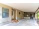 Spacious carport featuring a covered entryway, concrete flooring, and access to both the house and screened in porch at 149 E Plantation Blvd, Lake Mary, FL 32746