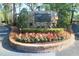 Stone monument marking the entrance to the Forest Club with colorful flowers and greenery at 149 E Plantation Blvd, Lake Mary, FL 32746