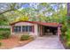 View of the home featuring mature landscaping, red shutters, and a long driveway at 149 E Plantation Blvd, Lake Mary, FL 32746