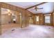 Spacious living room with carpet, wood paneling, and access to other living areas at 149 E Plantation Blvd, Lake Mary, FL 32746
