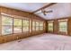 Cozy living room with carpet, wood paneling, and large windows offering natural light at 149 E Plantation Blvd, Lake Mary, FL 32746