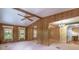 Spacious living room with carpet, wood paneled walls, and access to other living areas at 149 E Plantation Blvd, Lake Mary, FL 32746