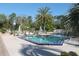 Large in-ground swimming pool featuring tropical palm trees, lounge chairs, and umbrellas for residents at 149 E Plantation Blvd, Lake Mary, FL 32746