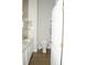 Well-lit bathroom showcasing a toilet, vanity with sink, and white door at 149 Southampton Dr, Kissimmee, FL 34744