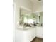 Bathroom with a long vanity, white cabinets, and a very large mirror at 149 Southampton Dr, Kissimmee, FL 34744