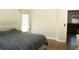 Well-lit bedroom features wood-look floors and a neutral color palette with access to a Primary bathroom at 149 Southampton Dr, Kissimmee, FL 34744
