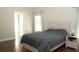 Bedroom with wood-look flooring and adjacent bathroom at 149 Southampton Dr, Kissimmee, FL 34744