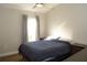 Bright bedroom featuring a bed, a nightstand, and a large window at 149 Southampton Dr, Kissimmee, FL 34744