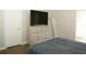 Comfortable bedroom with a dresser, large-screen television, and wood-look flooring at 149 Southampton Dr, Kissimmee, FL 34744