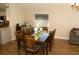 Dining area featuring a large dark wood table with seating for eight, a kitchen bar area, and bright lighting at 149 Southampton Dr, Kissimmee, FL 34744
