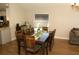 Dining area featuring a large dark wood table with seating for eight, a kitchen bar area, and bright lighting at 149 Southampton Dr, Kissimmee, FL 34744