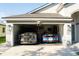 Spacious two-car garage featuring parking for a Shelby F150 and a Mustang with overhead lighting at 149 Southampton Dr, Kissimmee, FL 34744