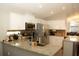 Open kitchen featuring granite countertops, stainless steel appliances, white cabinets, and recessed lighting at 149 Southampton Dr, Kissimmee, FL 34744