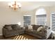 Cozy living room with comfortable sofas and plenty of natural light from large windows at 149 Southampton Dr, Kissimmee, FL 34744