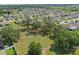 An aerial view showcases a community park surrounded by well-maintained homes in a tranquil neighborhood at 15250 Aquarius Way, Mascotte, FL 34753
