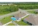 Aerial view of home showcasing a screened-in pool with a well-manicured lawn in a suburban neighborhood at 15250 Aquarius Way, Mascotte, FL 34753