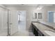 Bathroom featuring shower, vanity, tile floors, and easy bedroom access at 15250 Aquarius Way, Mascotte, FL 34753
