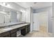 Bathroom boasts double vanity with granite counters and ample storage at 15250 Aquarius Way, Mascotte, FL 34753