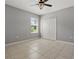 Cozy bedroom with tile flooring, neutral walls, and closet at 15250 Aquarius Way, Mascotte, FL 34753