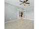 Bedroom with tile flooring and glass doors at 15250 Aquarius Way, Mascotte, FL 34753