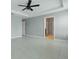 Spacious bedroom with tile floors, ceiling fan, and access to other rooms at 15250 Aquarius Way, Mascotte, FL 34753
