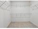 Walk-in closet with wire shelving for ample storage and tiled floor at 15250 Aquarius Way, Mascotte, FL 34753