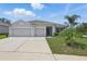 Charming single-story home with a well-manicured lawn and a spacious three-car driveway at 15250 Aquarius Way, Mascotte, FL 34753