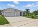 Charming single-story home with a well-manicured lawn and a spacious three-car driveway at 15250 Aquarius Way, Mascotte, FL 34753