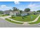 Corner lot home with a two-car garage, manicured lawn, and appealing curb appeal at 15250 Aquarius Way, Mascotte, FL 34753
