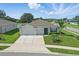 Desirable home with an attached two-car garage, and a beautifully landscaped front yard at 15250 Aquarius Way, Mascotte, FL 34753
