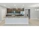 Modern kitchen with stainless steel appliances, a granite island, and plenty of cabinet space at 15250 Aquarius Way, Mascotte, FL 34753