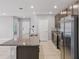 Beautiful kitchen with stainless steel appliances, granite countertops, and a large center island at 15250 Aquarius Way, Mascotte, FL 34753