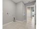 The laundry room features tile flooring and convenient access to utilities at 15250 Aquarius Way, Mascotte, FL 34753