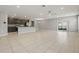 Bright open-concept living area with tile flooring, recessed lighting, and a kitchen with stainless appliances at 15250 Aquarius Way, Mascotte, FL 34753