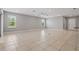 Bright open living area with tile flooring, recessed lighting, and large windows for natural light at 15250 Aquarius Way, Mascotte, FL 34753