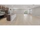 Spacious open-concept living area with tile floors, a ceiling fan, and sliding glass doors to the backyard at 15250 Aquarius Way, Mascotte, FL 34753