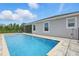 Private backyard pool with beautiful landscaping that offers a peaceful escape at 15250 Aquarius Way, Mascotte, FL 34753
