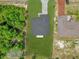 Bird's-eye view of single story home with well-manicured lawn, neutral paint, and dark roof at 15443 Sw 21St Ct, Ocala, FL 34473