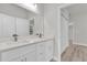 Modern bathroom with double sinks, quartz countertop, and a view into the bedroom at 15443 Sw 21St Ct, Ocala, FL 34473