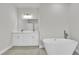Luxurious bathroom featuring a soaking tub and double vanity at 15443 Sw 21St Ct, Ocala, FL 34473