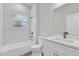 Clean bathroom showcasing marble tile, a bathtub and shower combination, and a modern vanity at 15443 Sw 21St Ct, Ocala, FL 34473