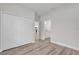 Neutral bedroom featuring a closet, white trim, and wood-look flooring at 15443 Sw 21St Ct, Ocala, FL 34473